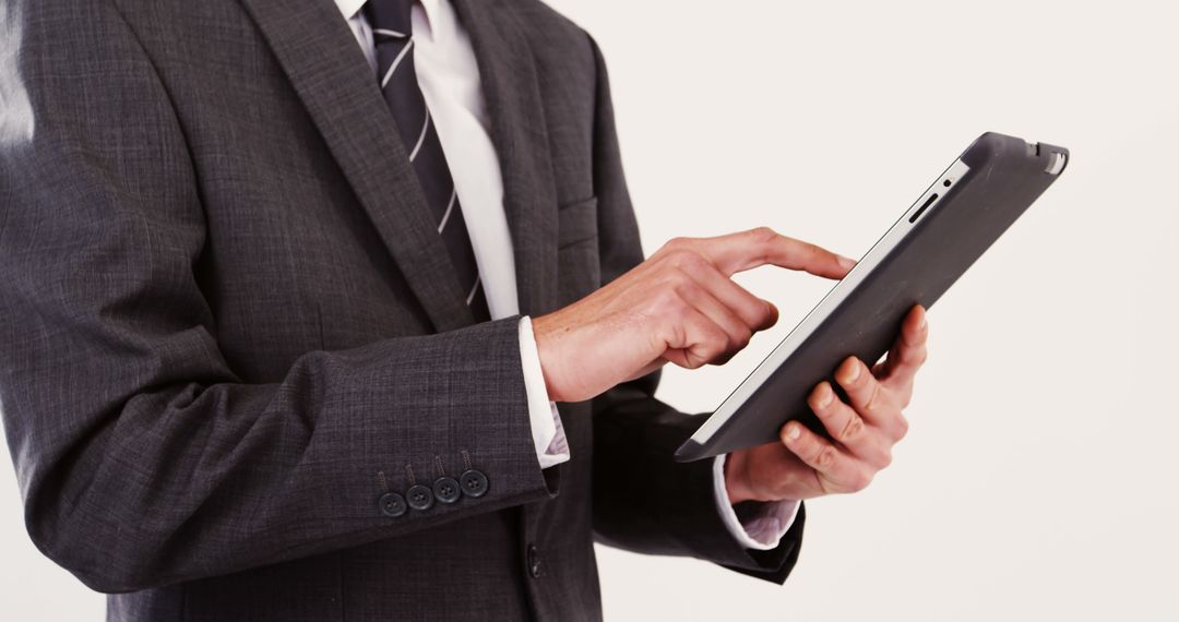 Businessperson Using Tablet Device in Professional Setting - Free Images, Stock Photos and Pictures on Pikwizard.com