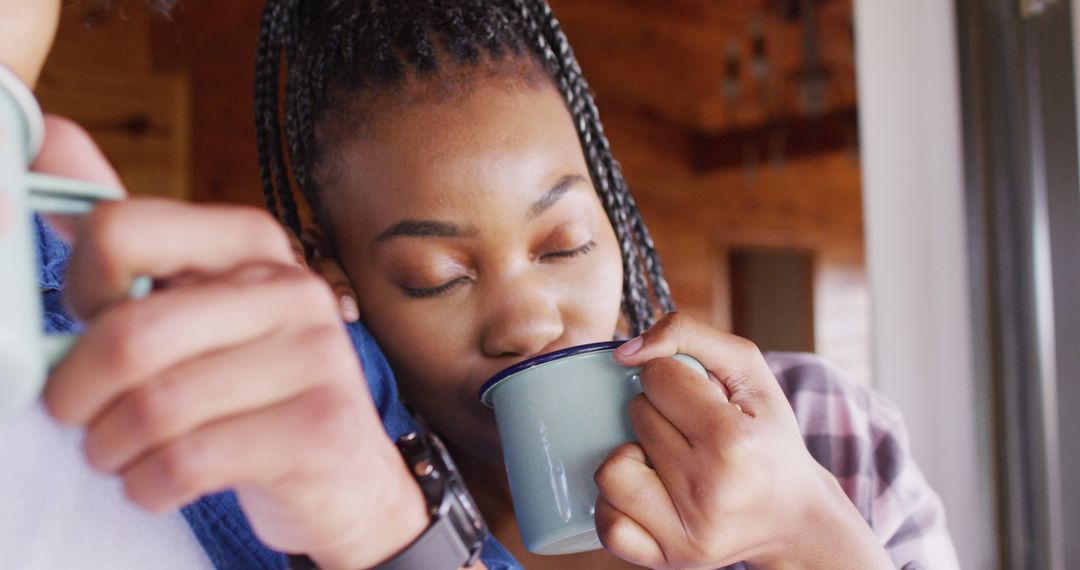 Woman Enjoying Hot Beverage Indoors with Eyes Closed - Free Images, Stock Photos and Pictures on Pikwizard.com