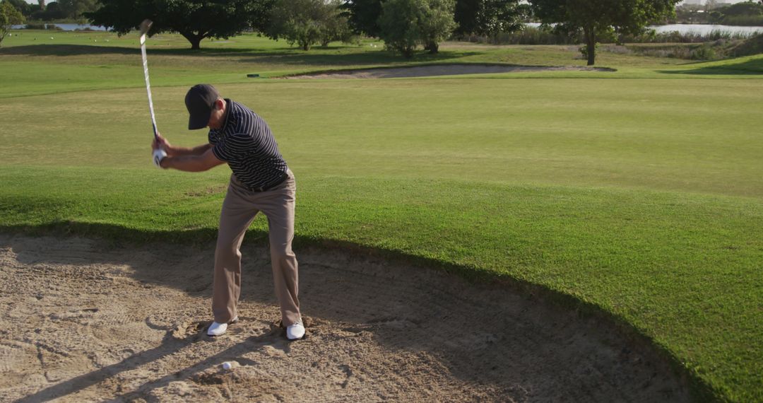 Golfer Executing Sand Bunker Shot with Precision and Skill