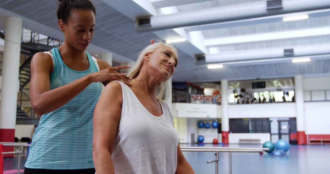 Personal Trainer Assisting Senior Woman with Neck Stretches at Gym - Free Images, Stock Photos and Pictures on Pikwizard.com