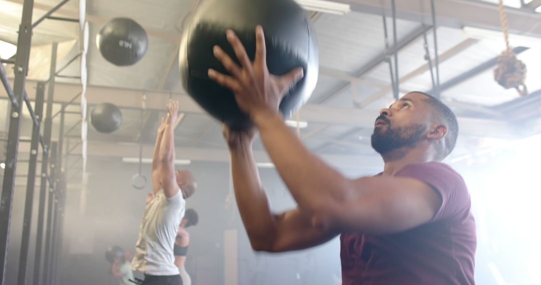 Athletic Man Focused on Medicine Ball Exercise at Gym - Free Images, Stock Photos and Pictures on Pikwizard.com