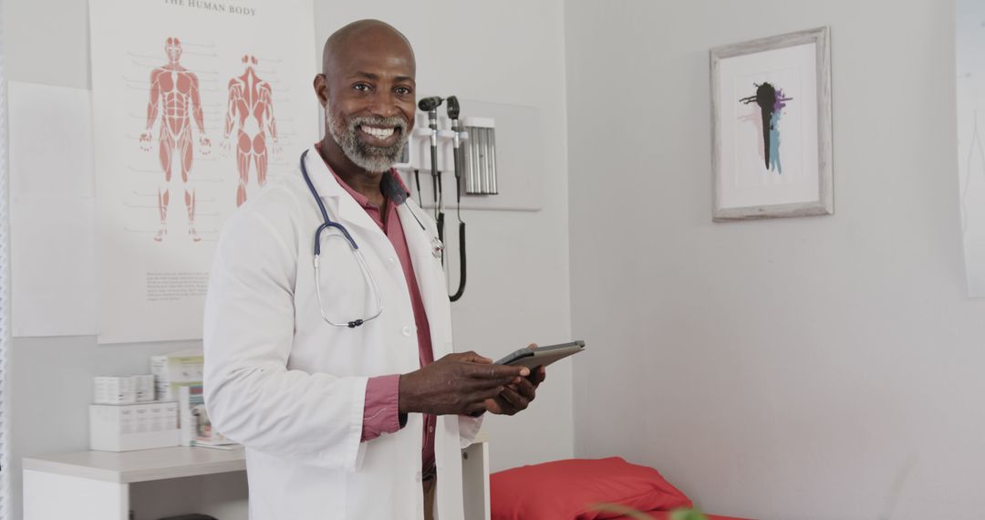 Confident African American Doctor Holding Tablet in Modern Clinic - Free Images, Stock Photos and Pictures on Pikwizard.com