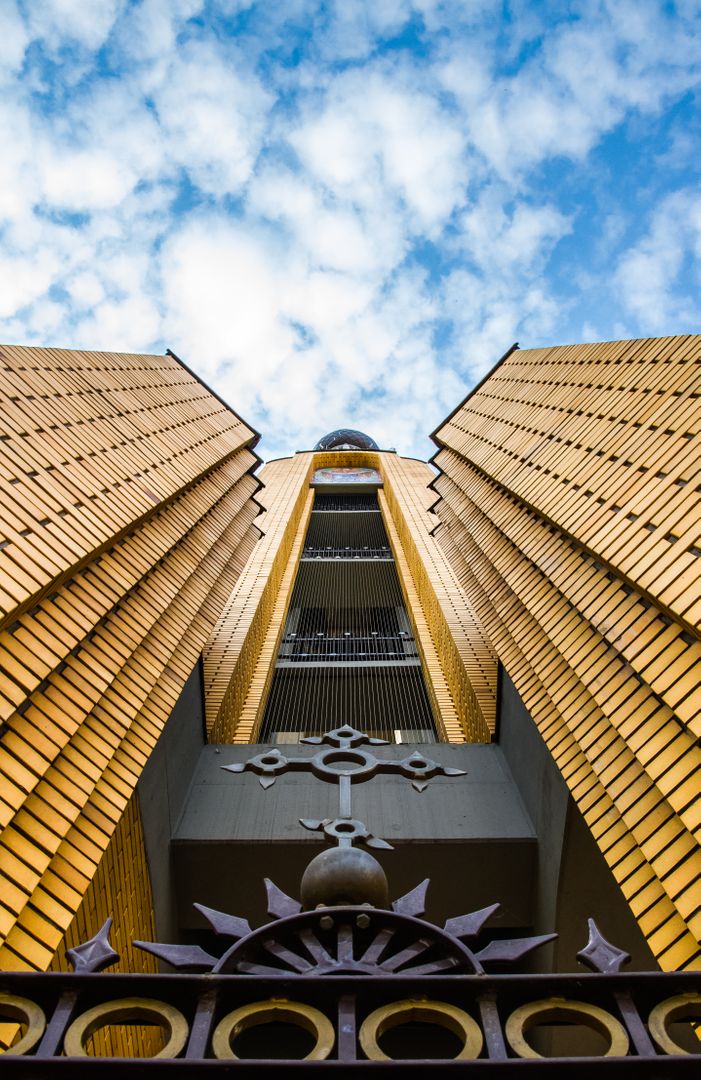 Modern yellow architectural building exterior with blue sky - Free Images, Stock Photos and Pictures on Pikwizard.com