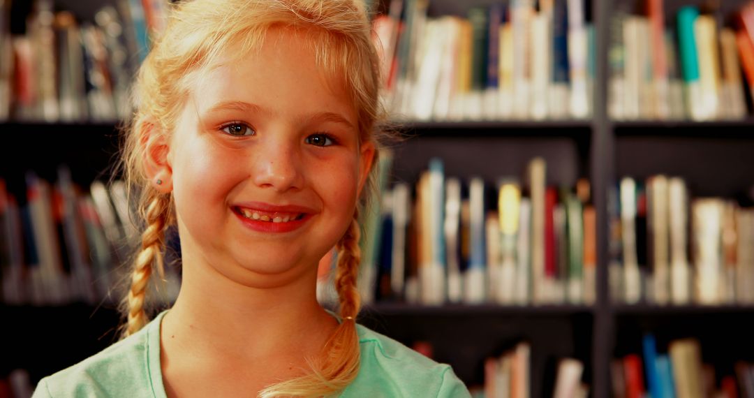 Smiling Schoolgirl With Braids in Library for Education Concept - Free Images, Stock Photos and Pictures on Pikwizard.com