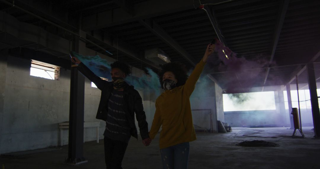 Couple in Industrial Space with Colorful Smoke Bombs - Free Images, Stock Photos and Pictures on Pikwizard.com