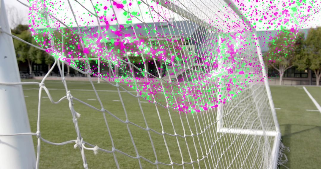 Curving soccer goal net with magenta and green particle overlay on outdoor turf field