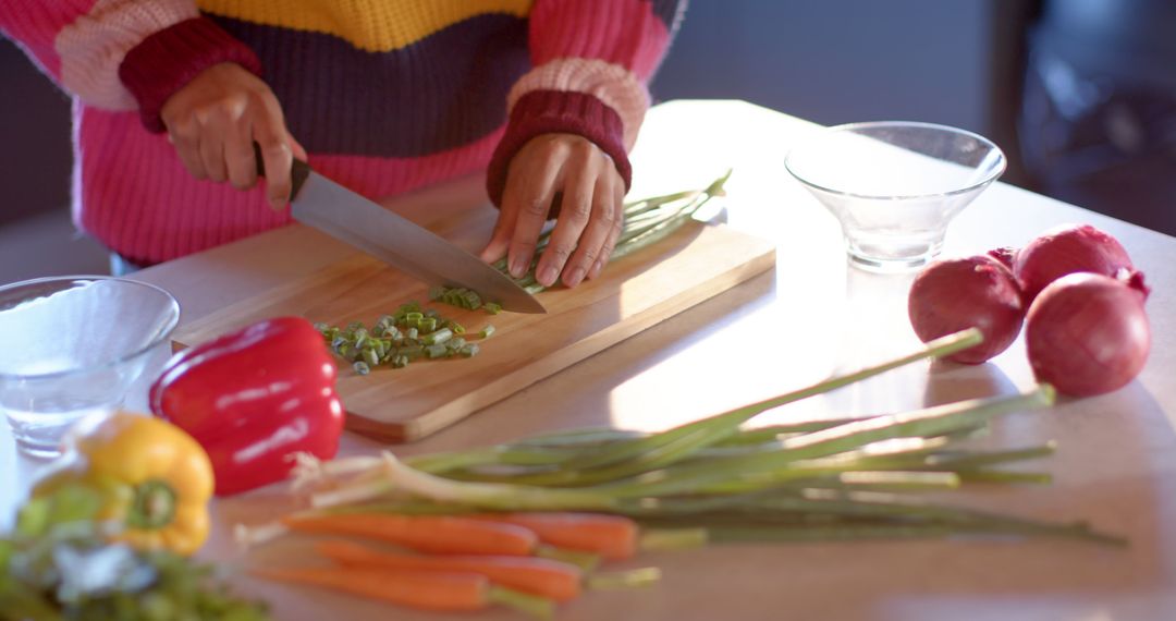 Person chopping fresh vegetables on kitchen counter - Free Images, Stock Photos and Pictures on Pikwizard.com