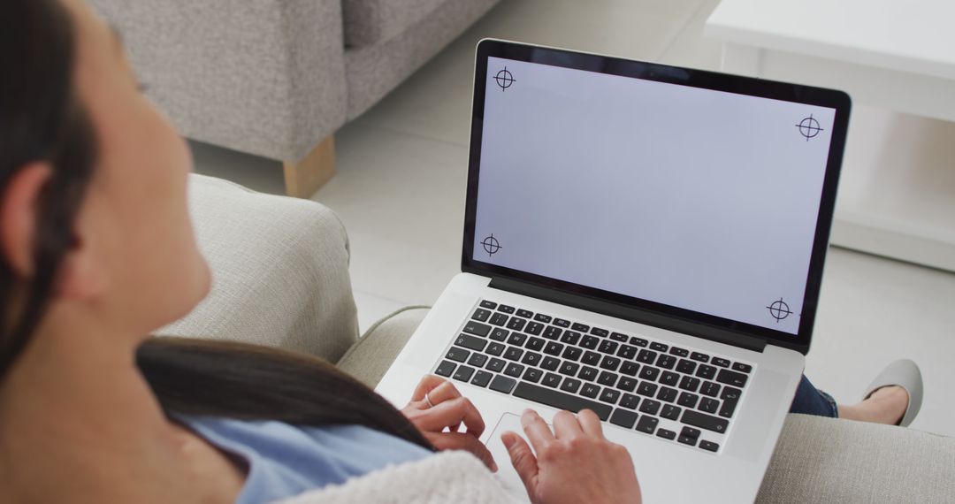 Person using laptop with blank screen on couch - Free Images, Stock Photos and Pictures on Pikwizard.com