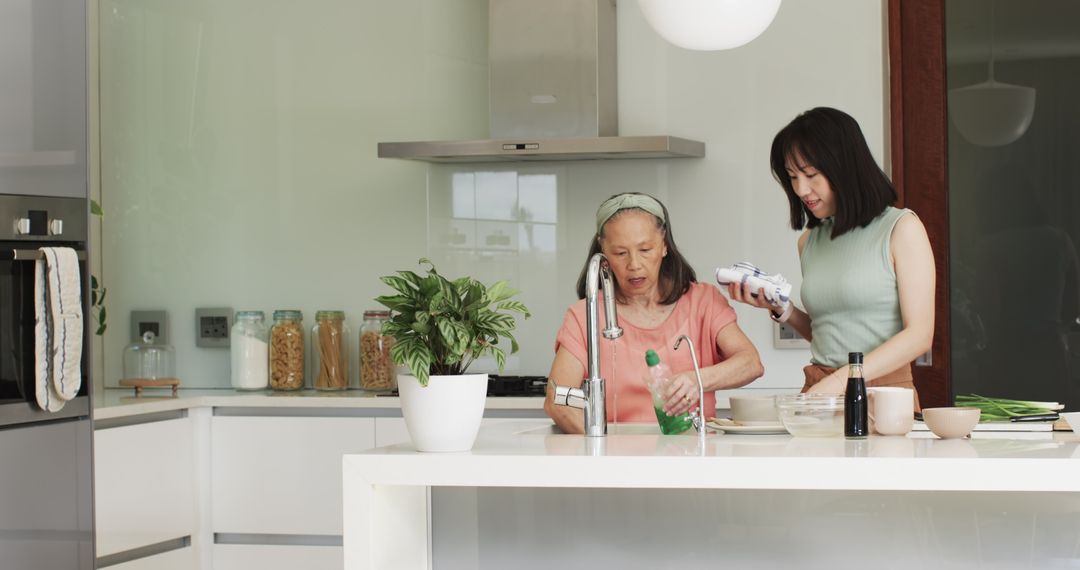 Generations Bonding in Minimalist Kitchen While Clean Dishes