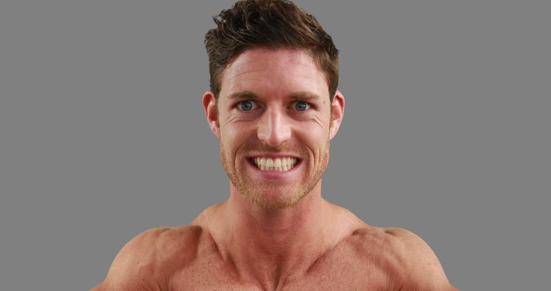 Smiling Fit Man Showing Muscles on Gray Background - Free Images, Stock Photos and Pictures on Pikwizard.com