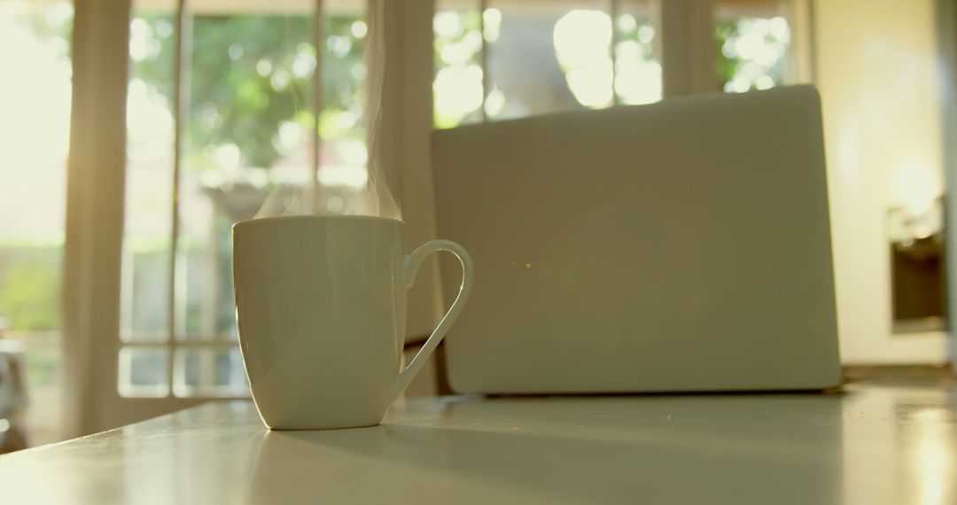 Morning Routine with Warm Coffee and Laptop on Kitchen Table - Free Images, Stock Photos and Pictures on Pikwizard.com