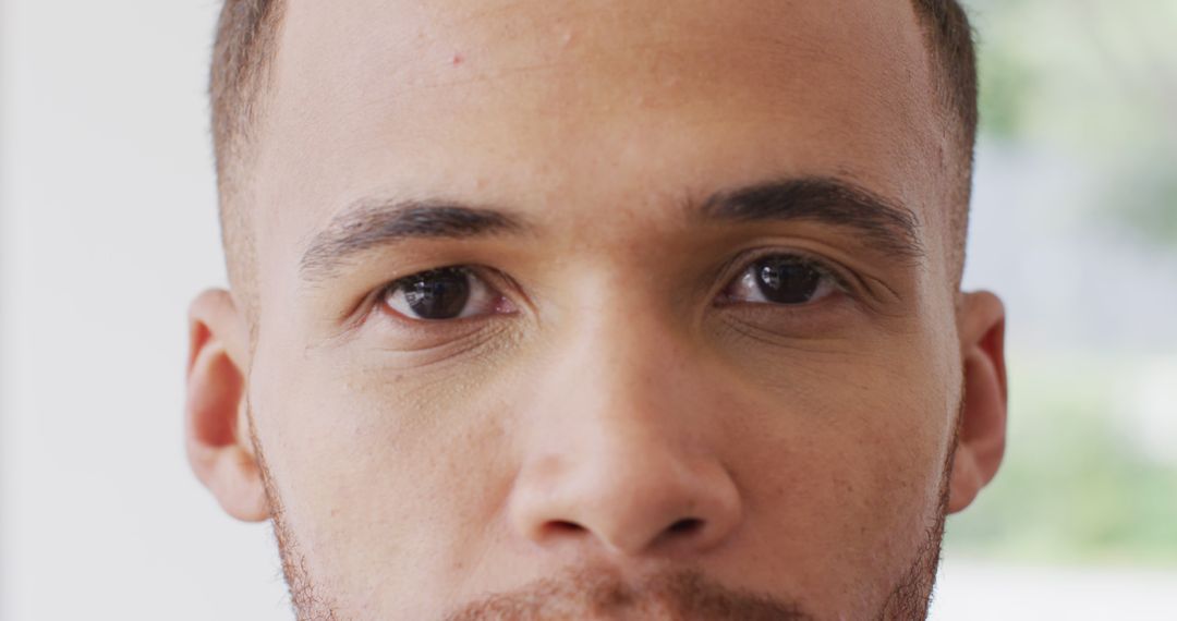 Close-up Portrait of Biracial Man Smiling Indoors