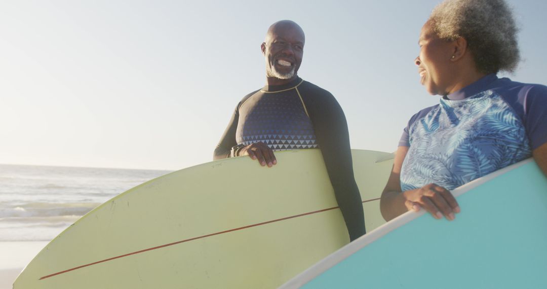 Senior Couple Preparing to Surf at Beach - Free Images, Stock Photos and Pictures on Pikwizard.com