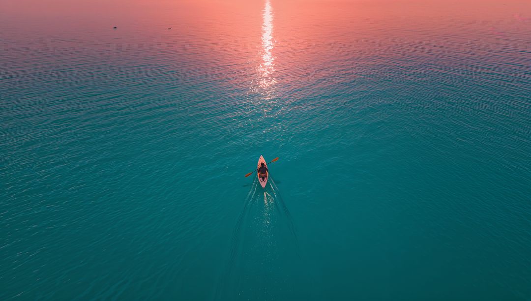 Solo Kayaker Gliding Across Ocean at Sunset With Stunning Reflection