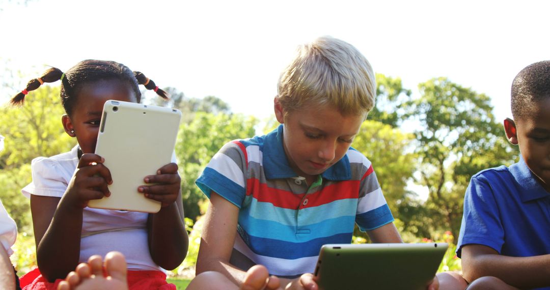 Children Using Tablets Outdoors on Sunny Day - Free Images, Stock Photos and Pictures on Pikwizard.com