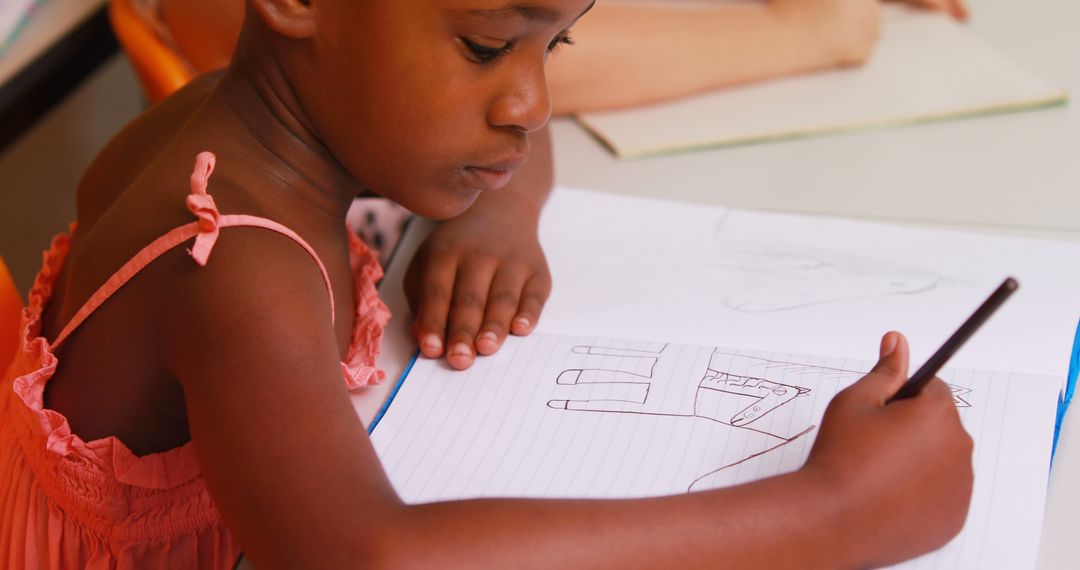 Young girl drawing with pencil in notebook - Free Images, Stock Photos and Pictures on Pikwizard.com