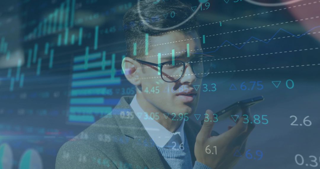 Asian businessman speaking into smartphone with overlaid stock charts, trading analytics