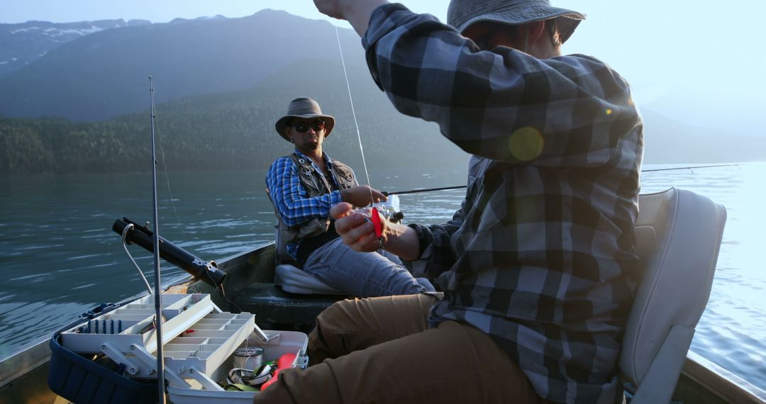 Two middle-aged Caucasian men are enjoying a fishing trip on a serene lake, with copy space - Free Images, Stock Photos and Pictures on Pikwizard.com