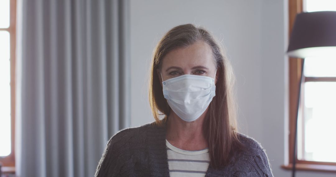 Woman Wearing Surgical Mask Indoors During Pandemic - Free Images, Stock Photos and Pictures on Pikwizard.com