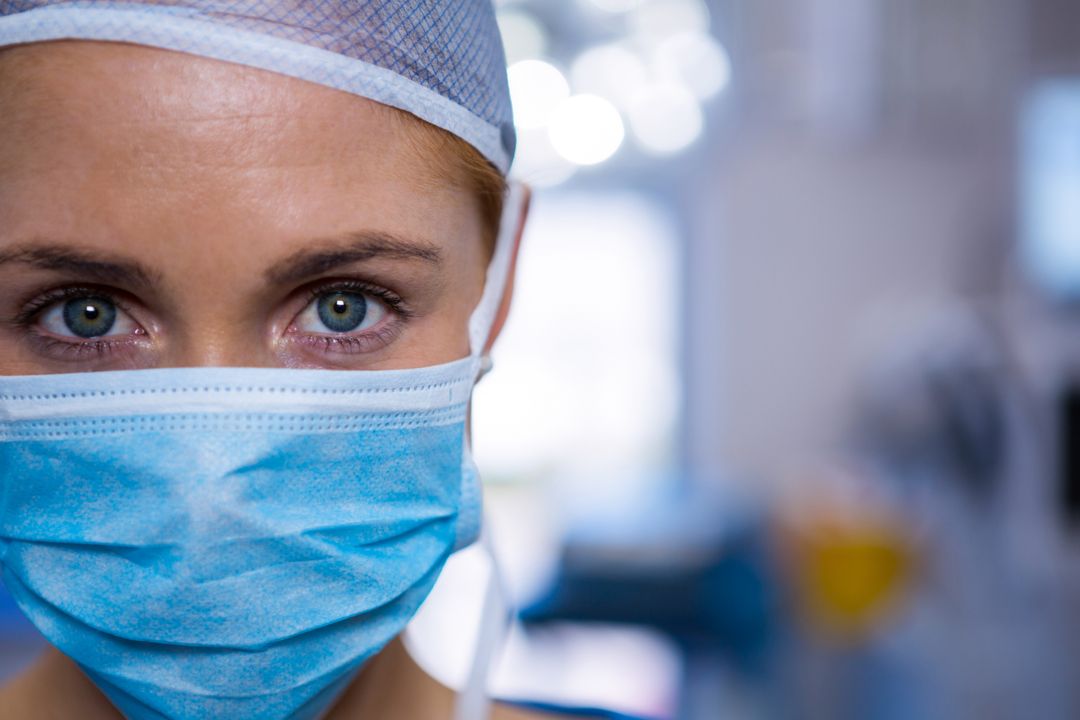 Portrait of female surgeon wearing surgical mask in operation theater - Free Images, Stock Photos and Pictures on Pikwizard.com