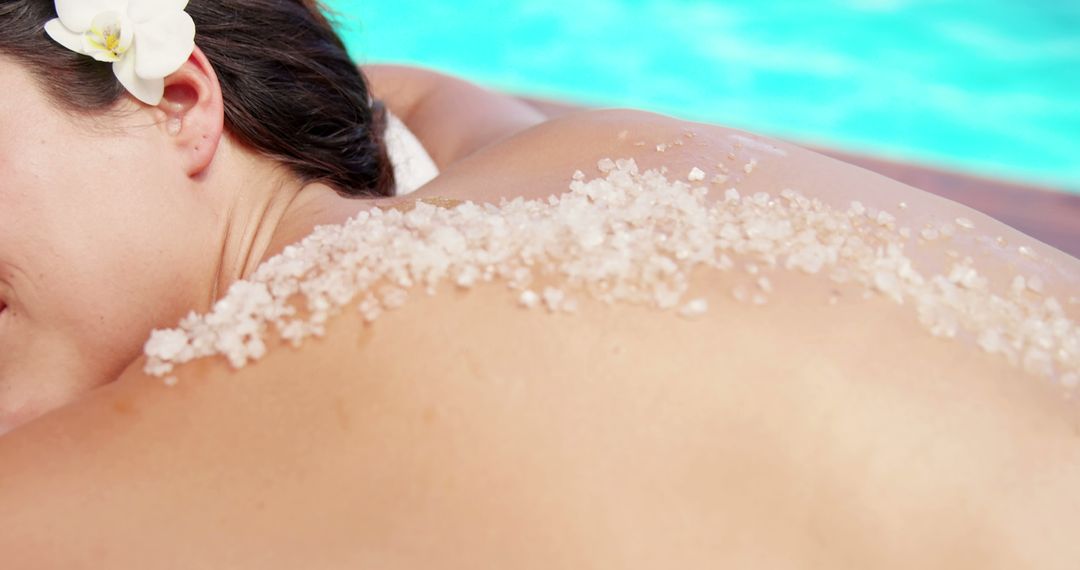 Woman Enjoying Relaxing Salt Scrub by Poolside - Free Images, Stock Photos and Pictures on Pikwizard.com