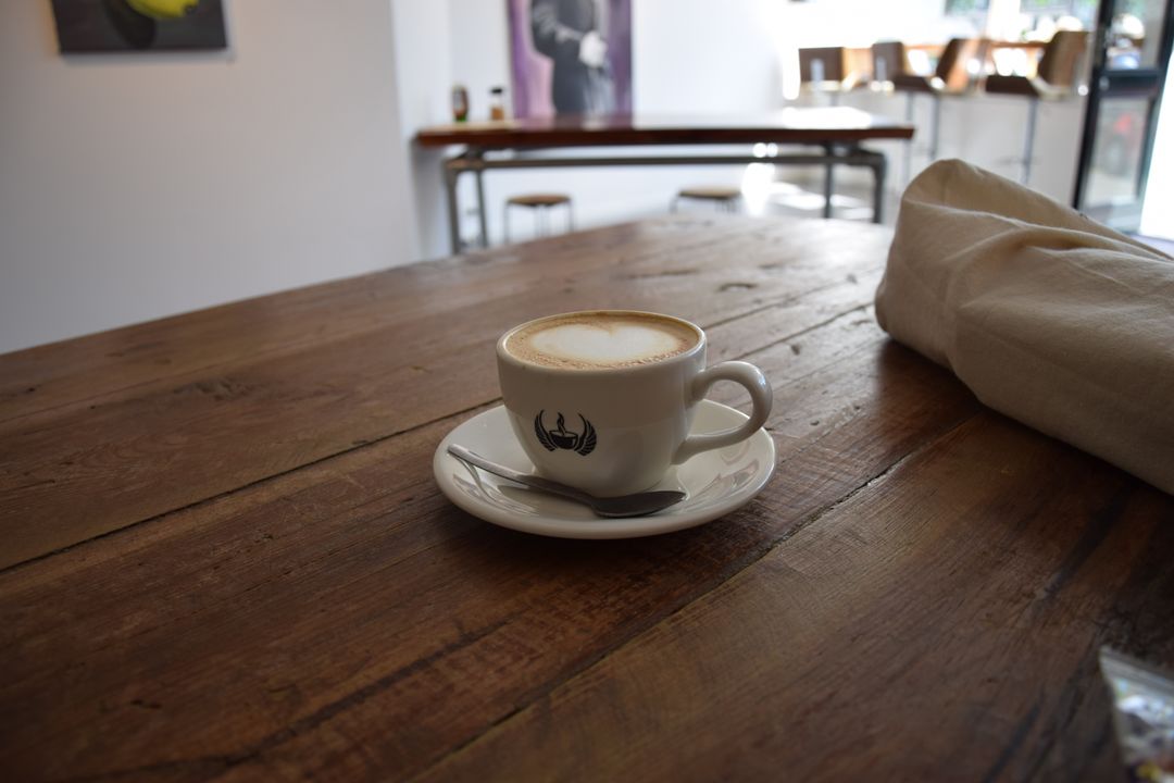 Coffee Cup on Rustic Wooden Table in Modern Café