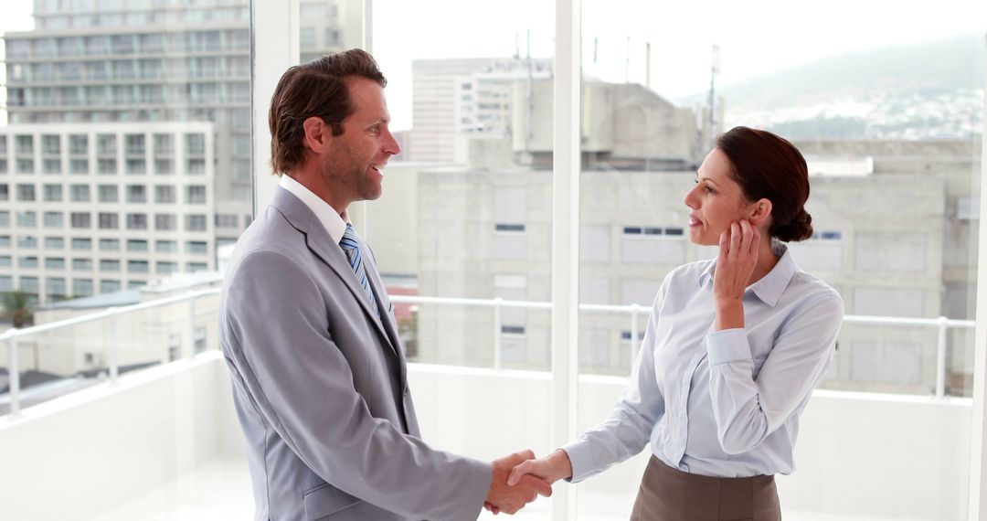 Business people shaking hands in modern office - Free Images, Stock Photos and Pictures on Pikwizard.com