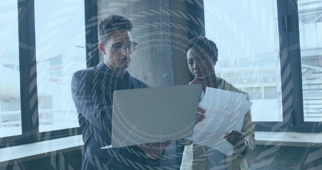 Business Collaboration Analysts Reviewing Documents by Large Window