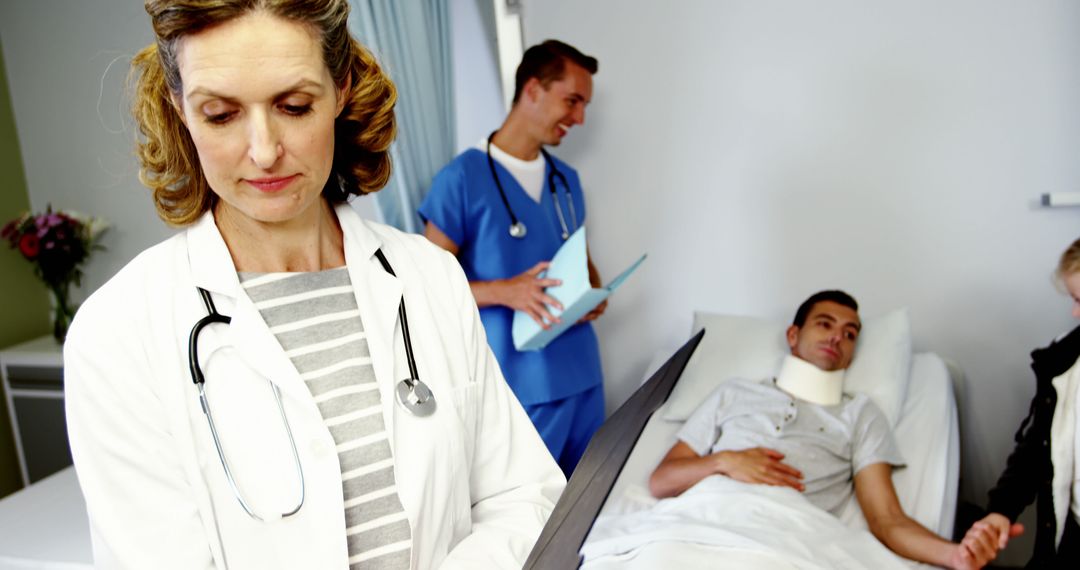 Hospital Doctor Examining Patient with Neck Brace in Bed - Free Images, Stock Photos and Pictures on Pikwizard.com