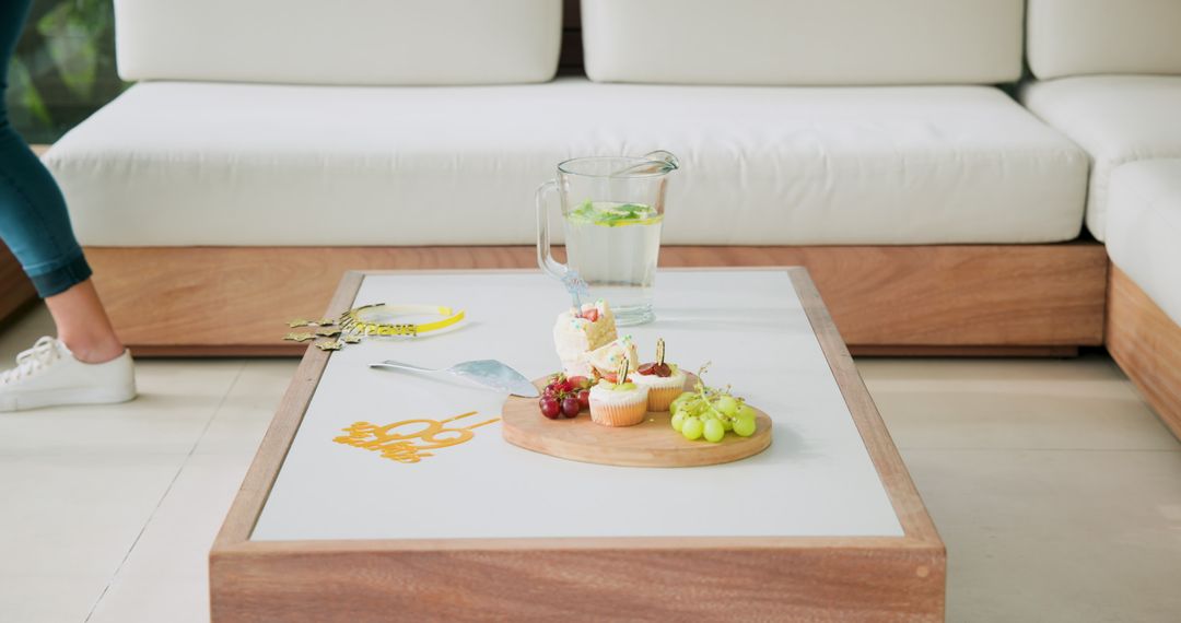 Lemonade Pitcher and Snacks on Coffee Table in Bright Room