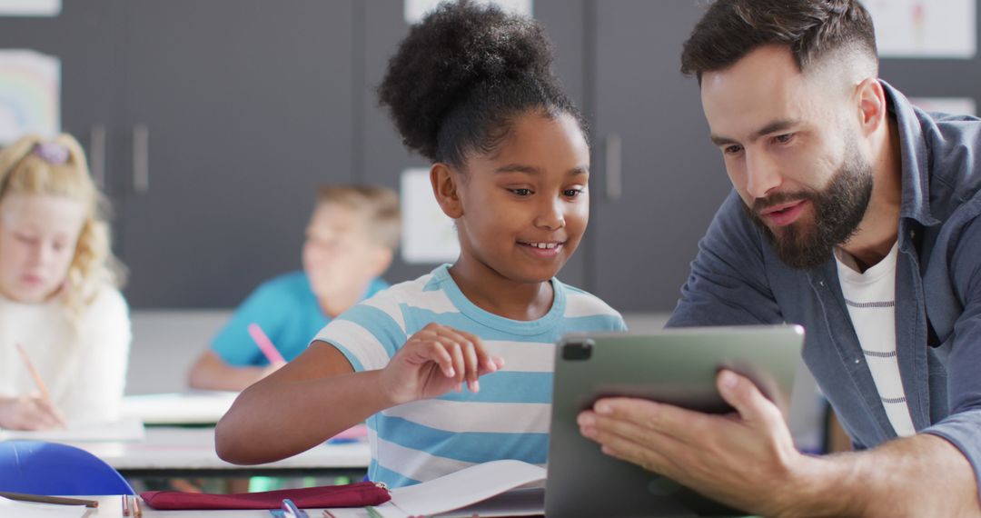 Engaged Teacher Helping Student with Tablet in Classroom