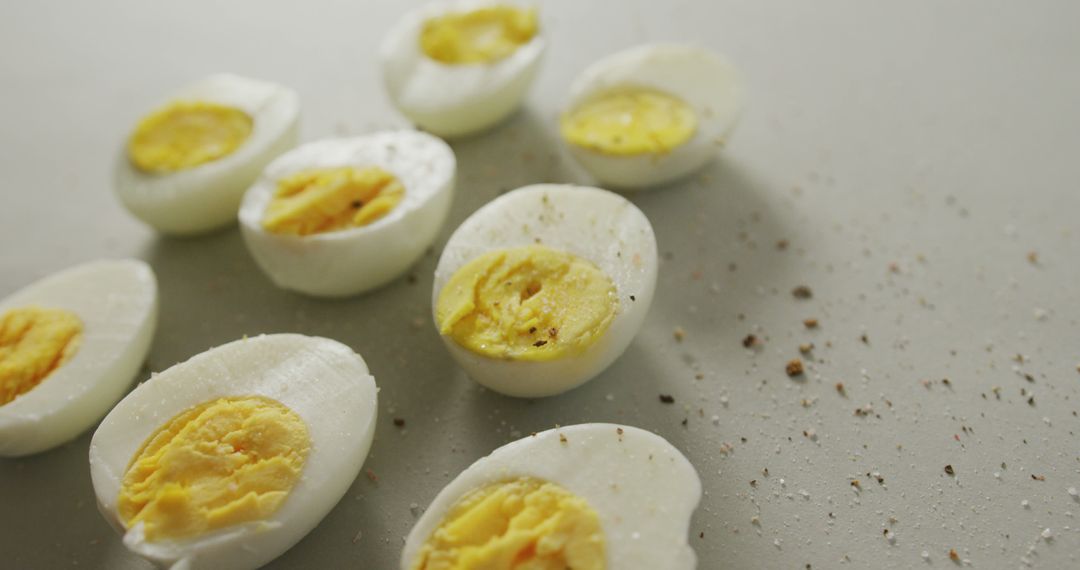 Halved Boiled Eggs Topped with Seasoning on a Clean Surface - Free Images, Stock Photos and Pictures on Pikwizard.com