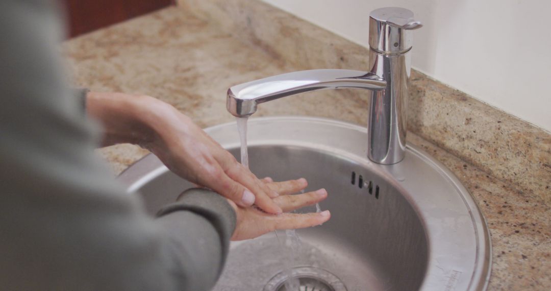 Close-Up of Hands Washing Under Running Water in Kitchen Sink - Free Images, Stock Photos and Pictures on Pikwizard.com