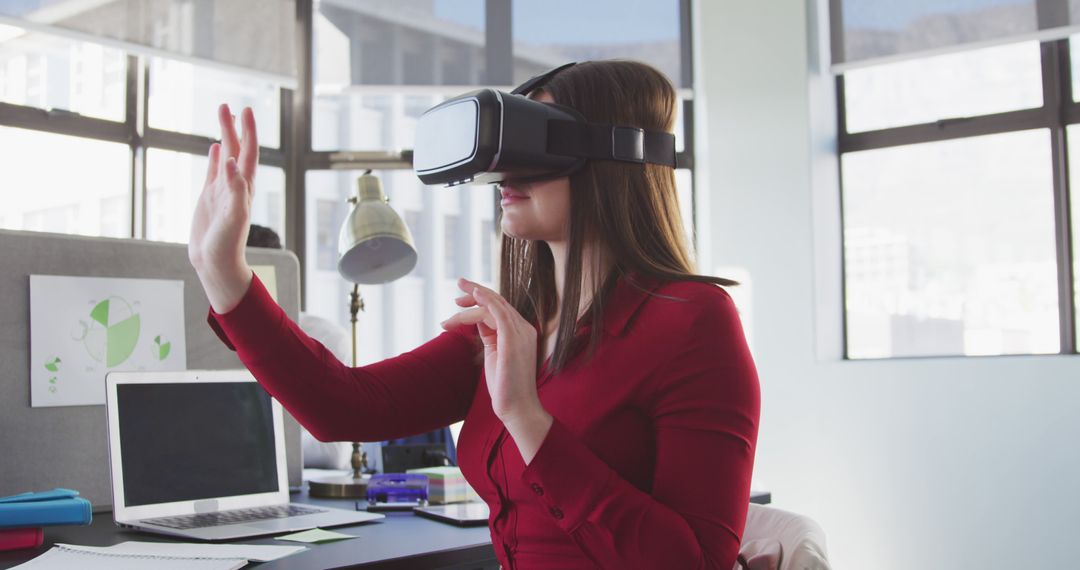 Businesswoman Experiencing Virtual Reality Technology at Office - Free Images, Stock Photos and Pictures on Pikwizard.com