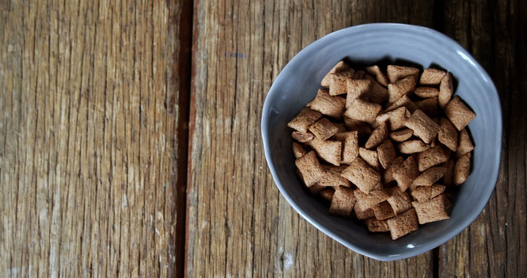 Bowl of Whole-Grain Brown Cereal on Wooden Table - Free Images, Stock Photos and Pictures on Pikwizard.com