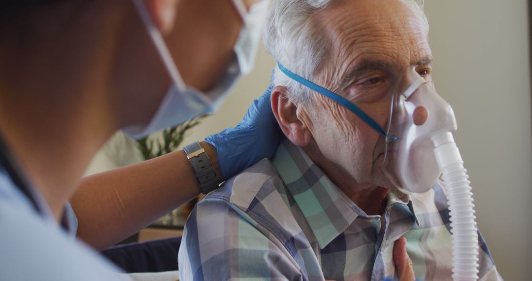 Healthcare Worker Assists Elderly Man with Oxygen Mask - Free Images, Stock Photos and Pictures on Pikwizard.com