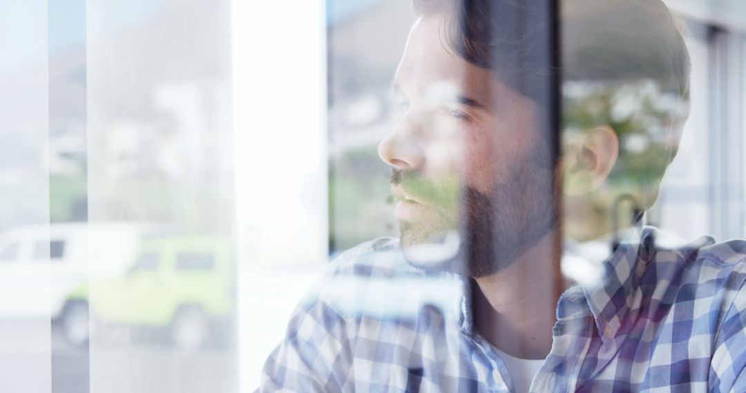 Pensive Businessman Reflecting Behind Glass Pane - Free Images, Stock Photos and Pictures on Pikwizard.com