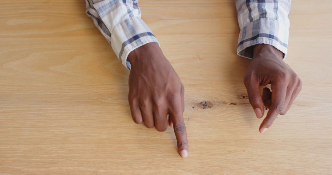 Hands Gesturing on Wooden Table in Business Discussion