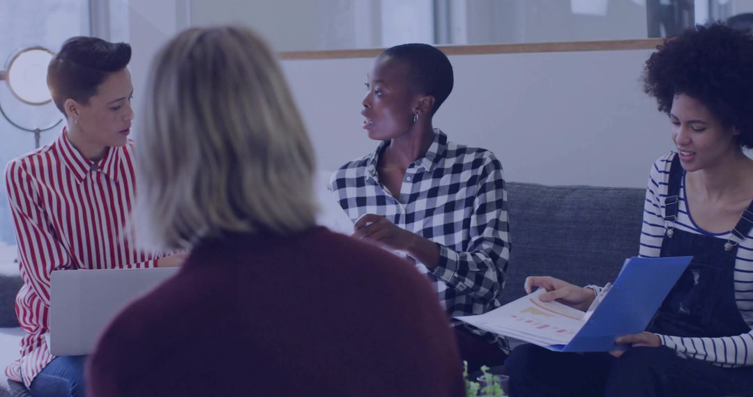 Diverse Professional Team Engages in Modern Office Discussion