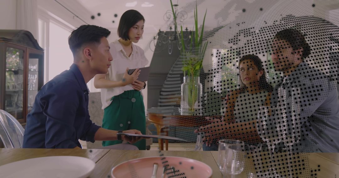 Hybrid team collaborating at dining table with tablet and halftone projection overlay