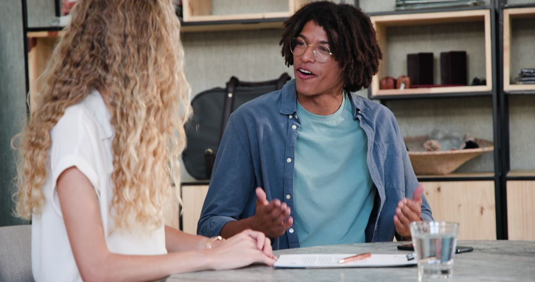 Young Professionals Engaged in Dynamic Office Discussion