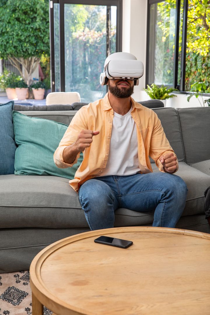 Man Engaging with Virtual Reality Headset in Comfortable Living Room