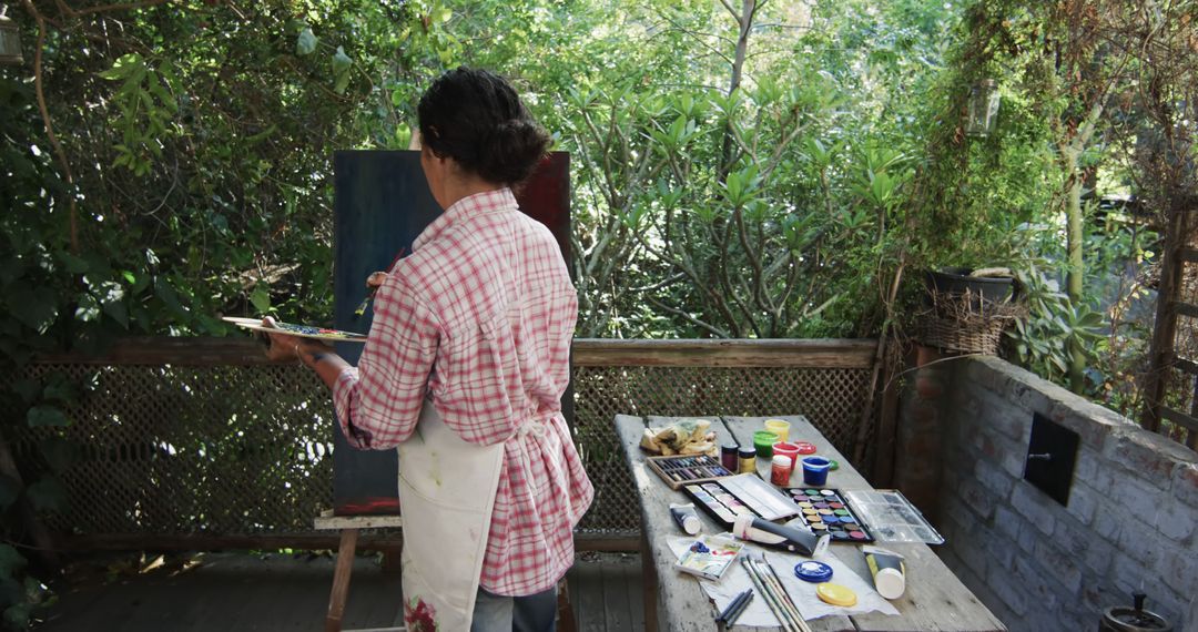 Artist Painting Outdoors in Lush Garden - Free Images, Stock Photos and Pictures on Pikwizard.com