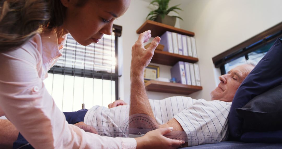 Physical Therapist Helping Senior Man with Arm Rehabilitation Exercise - Free Images, Stock Photos and Pictures on Pikwizard.com