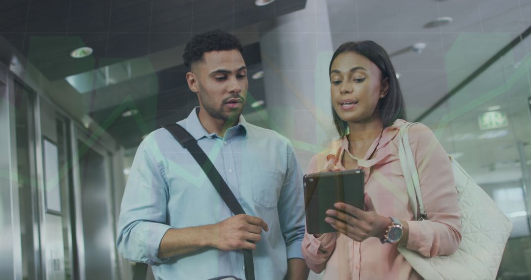 Colleagues Discussing Financial Strategy Insights on Tablet