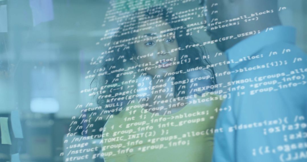 Diverse Team Collaborating on Computer Code in Modern Office