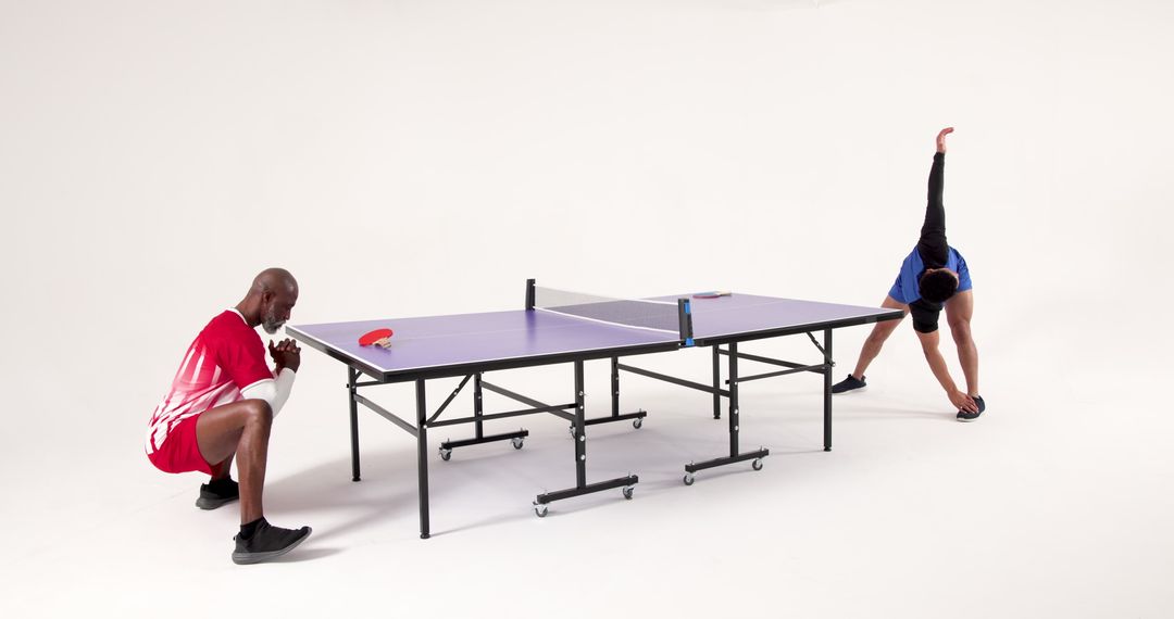 Diverse Men Stretching by Ping-Pong Table Fitness and Teamwork