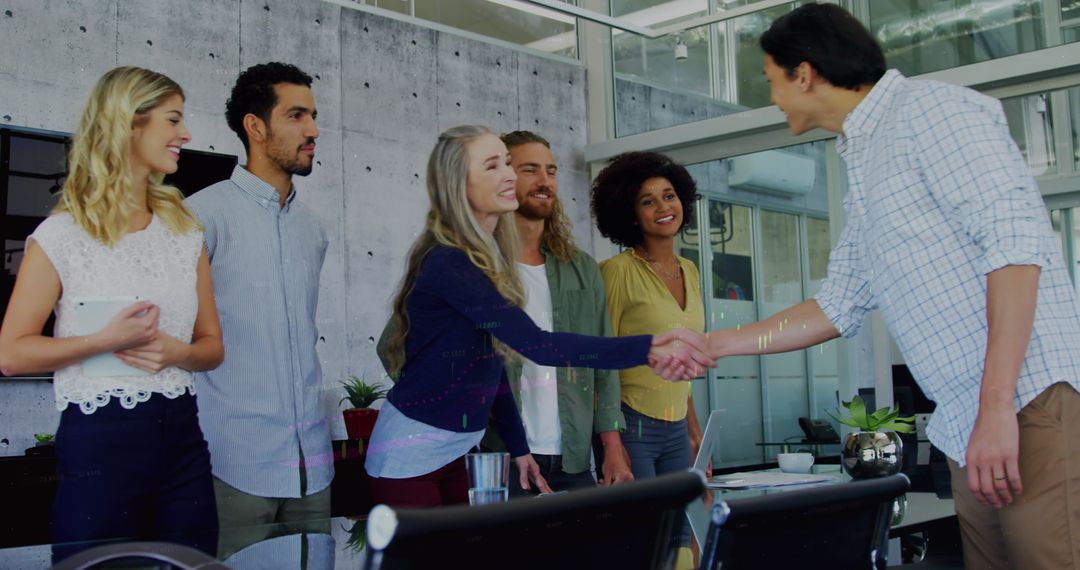 Diverse Business Team Handshaking in Modern Office Environment