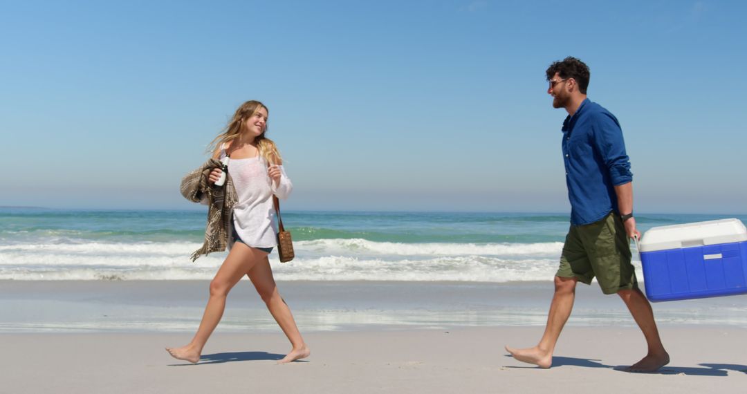 Couple Enjoying Beach Day by Ocean Waves - Free Images, Stock Photos and Pictures on Pikwizard.com