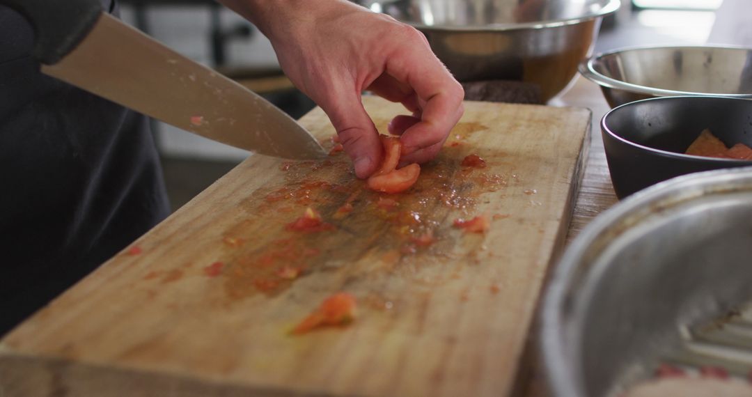 Chef Slicing Fresh Tomato on Wooden Cutting Board - Free Images, Stock Photos and Pictures on Pikwizard.com